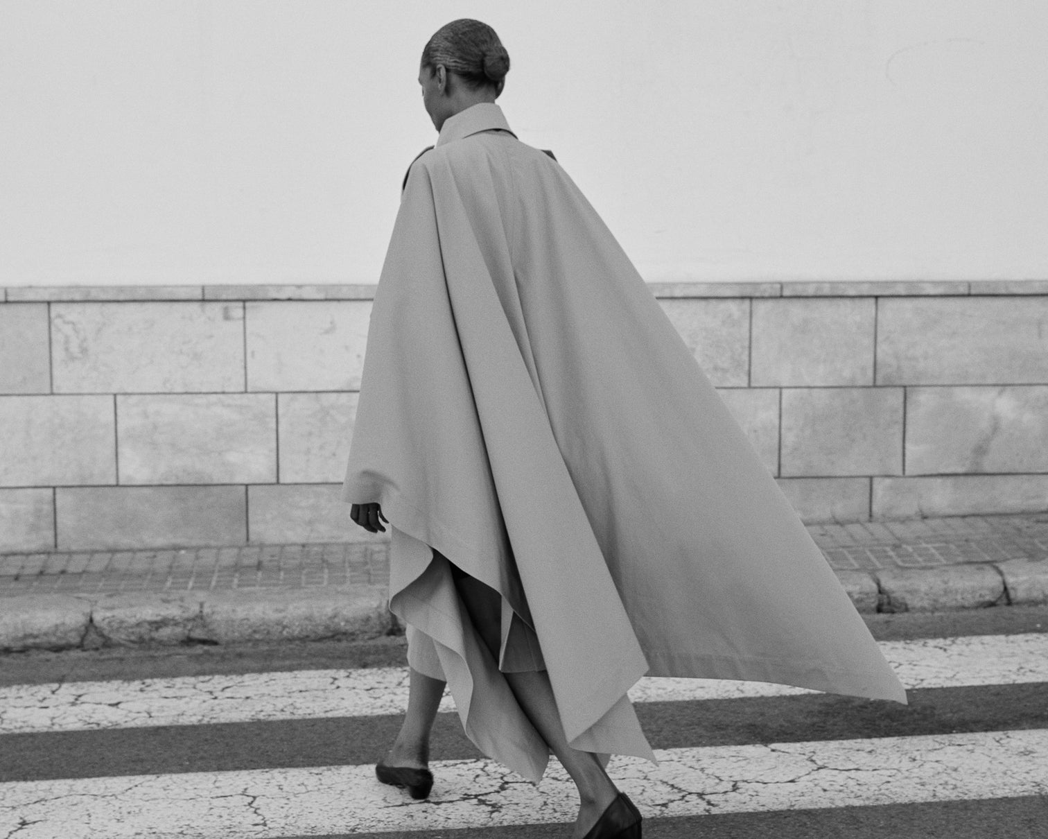 Model wearing a flowing contemporary coat